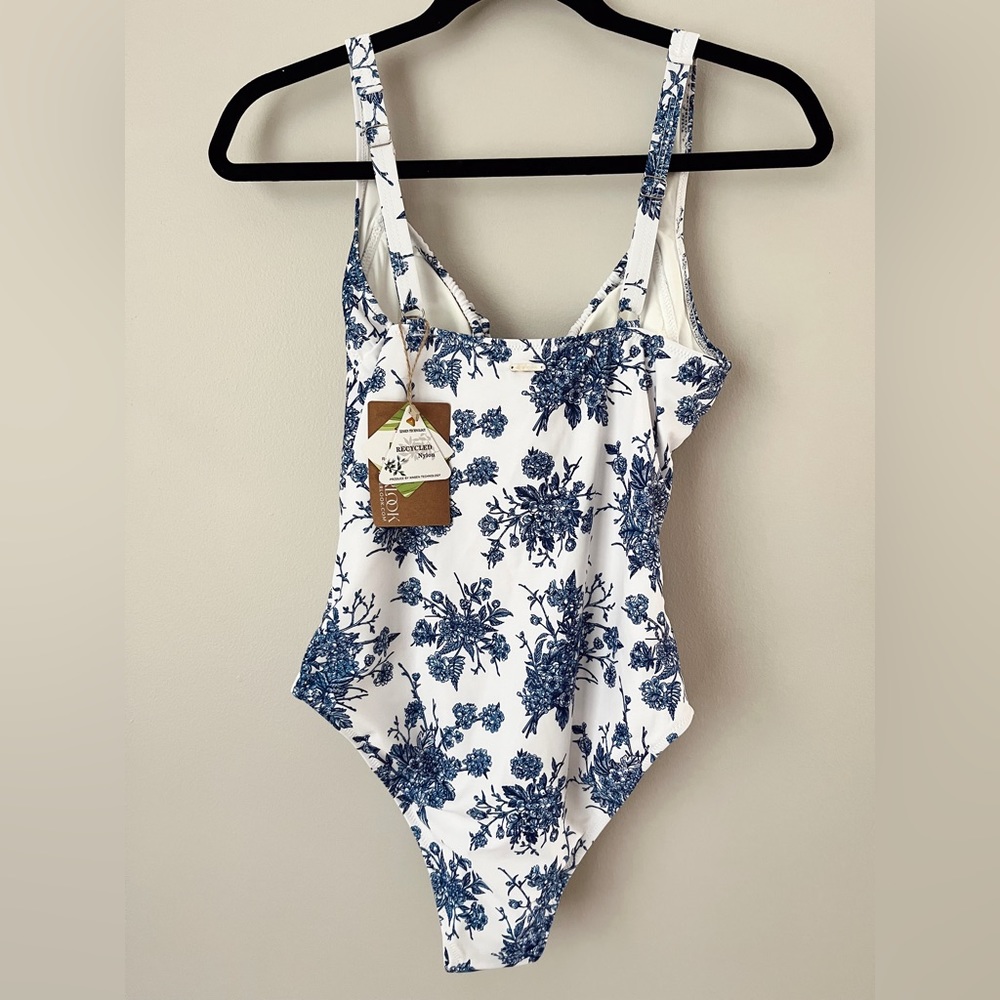 Never worn one piece swimsuit. Beautiful blue floral design